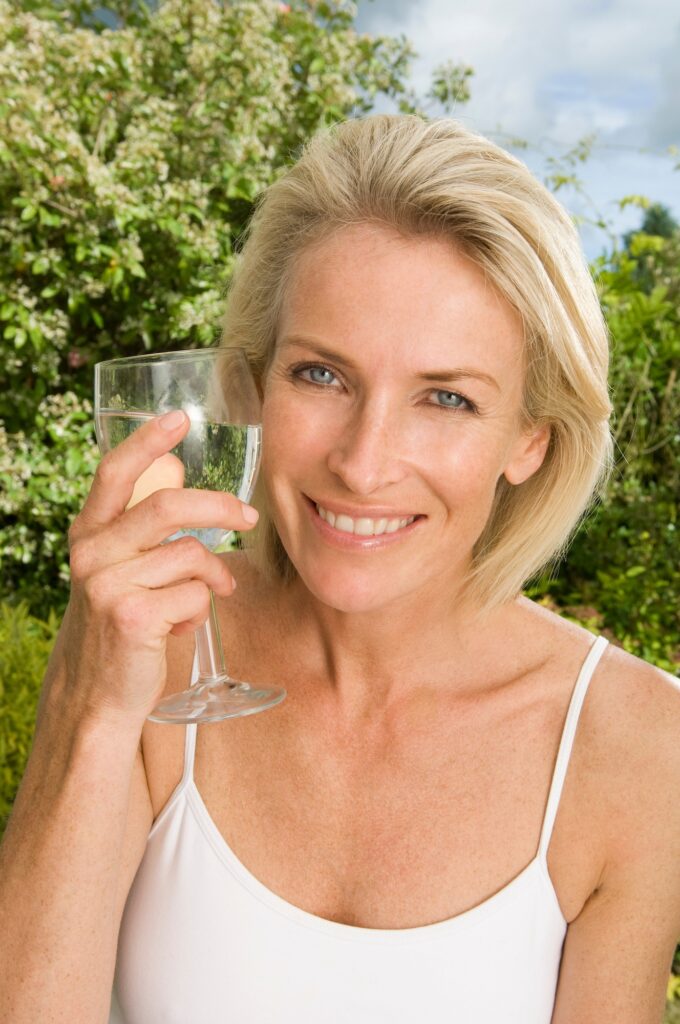 Portrait of woman with glass of water